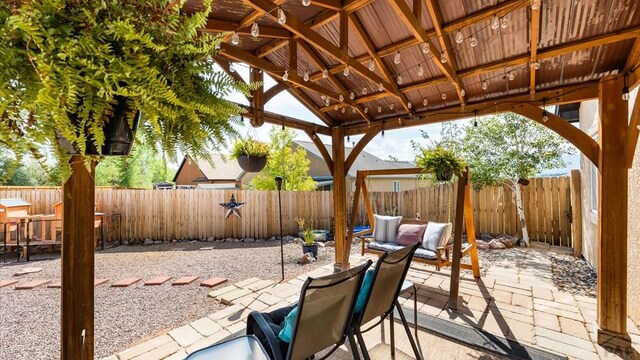 view of patio featuring a gazebo and a fenced backyard