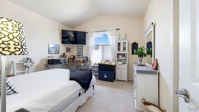 bedroom featuring lofted ceiling and light colored carpet