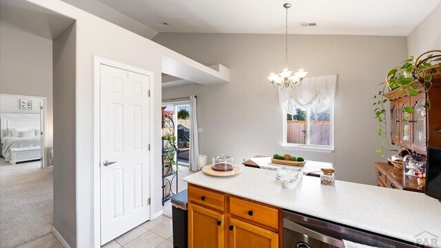 kitchen featuring brown cabinetry, light countertops, visible vents, and decorative light fixtures