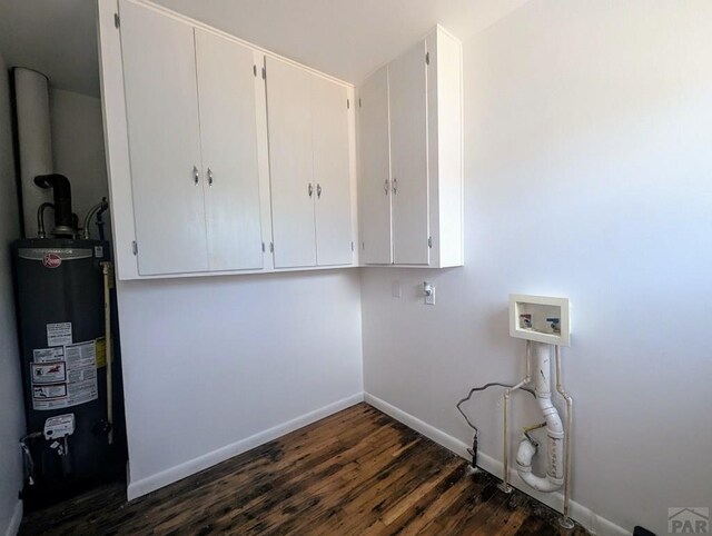 laundry area with washer hookup, gas water heater, dark wood finished floors, cabinet space, and baseboards