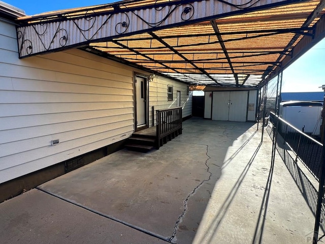 view of patio / terrace with a storage shed and a water view