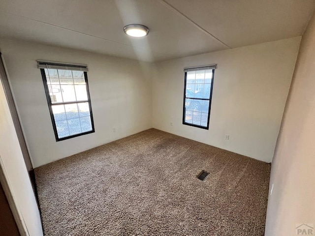 carpeted empty room with visible vents