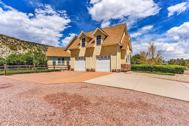611 Rock Ridge Loop, Canon City, CO 81212 - view of front of property featuring stucco siding, driveway, a shingled roof, and an attached garage