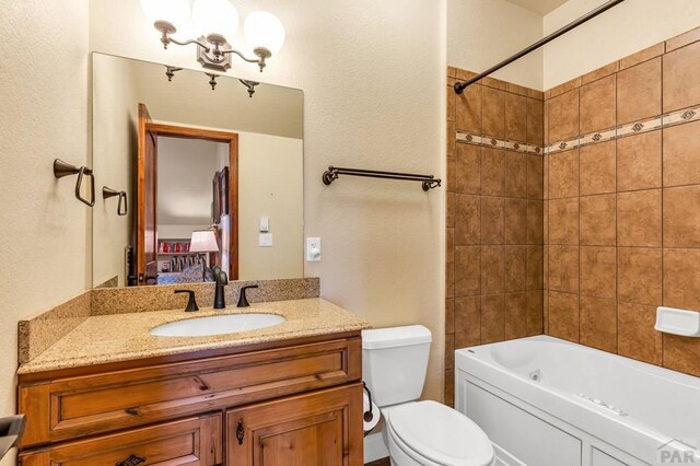 611 Rock Ridge Loop, Canon City, CO 81212 - ensuite bathroom featuring toilet, vanity, and bathing tub / shower combination