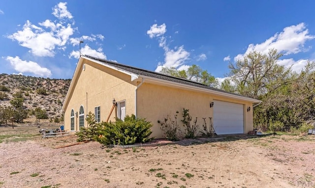 611 Rock Ridge Loop, Canon City, CO 81212 - view of side of home with stucco siding and a garage