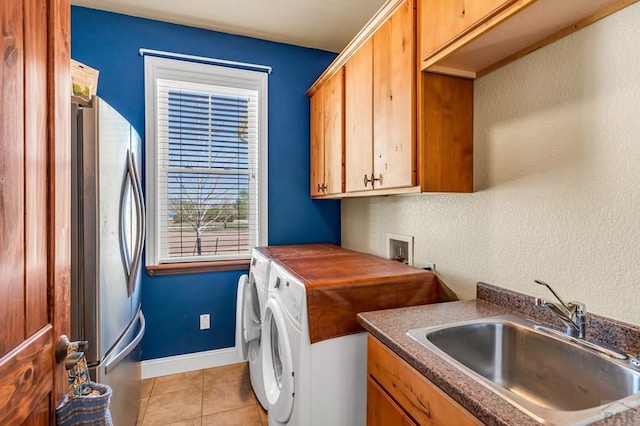 611 Rock Ridge Loop, Canon City, CO 81212 - laundry area featuring light tile patterned flooring, cabinet space, independent washer and dryer, and baseboards