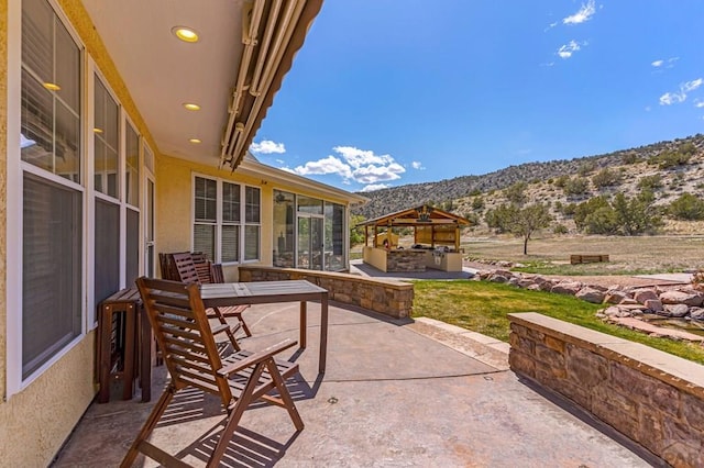 611 Rock Ridge Loop, Canon City, CO 81212 - view of patio / terrace with a mountain view, a gazebo, a sunroom, and an outdoor kitchen
