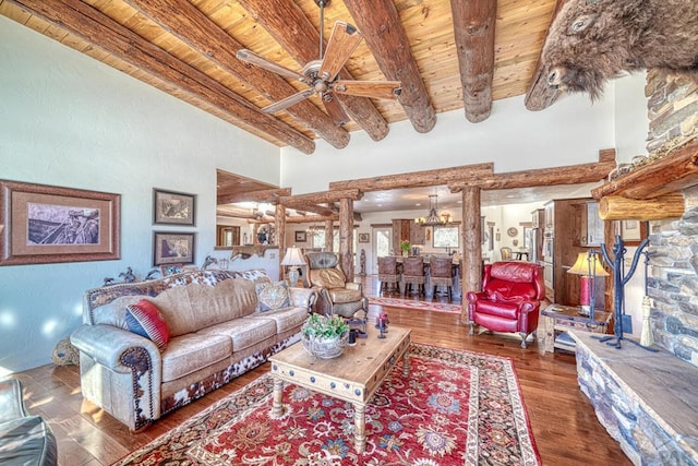 living area featuring decorative columns, wooden ceiling, beamed ceiling, dark wood-style flooring, and ceiling fan with notable chandelier