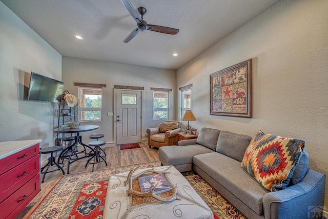 living area featuring recessed lighting, ceiling fan, and light wood-style flooring