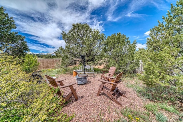 view of yard featuring a fire pit and fence