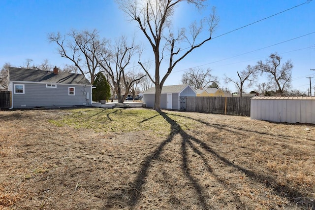 view of yard featuring an outdoor structure and fence