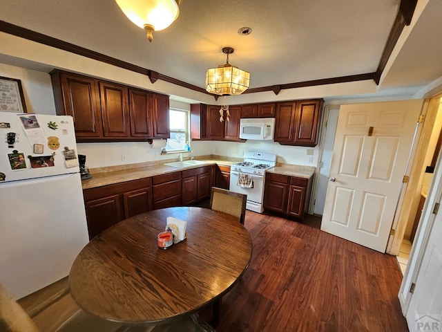 597 Piute Rd, Westcliffe, CO 81252 - kitchen featuring white appliances, light countertops, dark wood-style floors, crown molding, and a sink