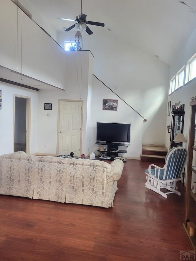 597 Piute Rd, Westcliffe, CO 81252 - living area featuring high vaulted ceiling, dark wood-style flooring, a ceiling fan, and baseboards