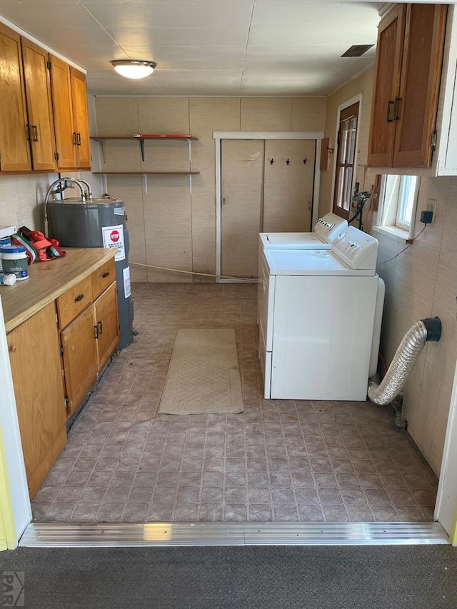 washroom featuring cabinet space and separate washer and dryer