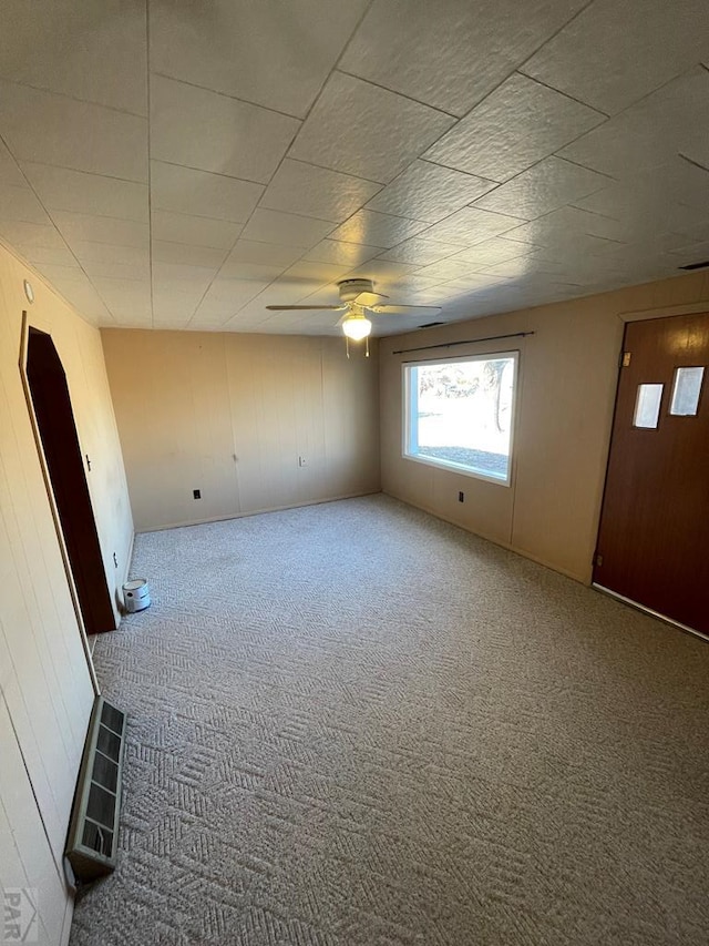 empty room featuring ceiling fan and carpet flooring