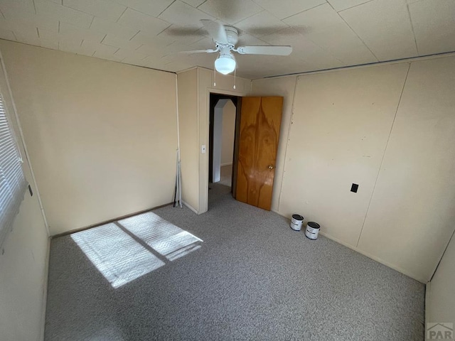 unfurnished bedroom with carpet floors and a ceiling fan