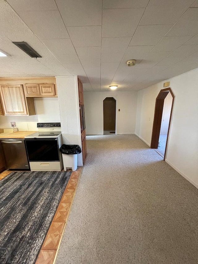 kitchen with arched walkways, electric stove, light countertops, and stainless steel dishwasher