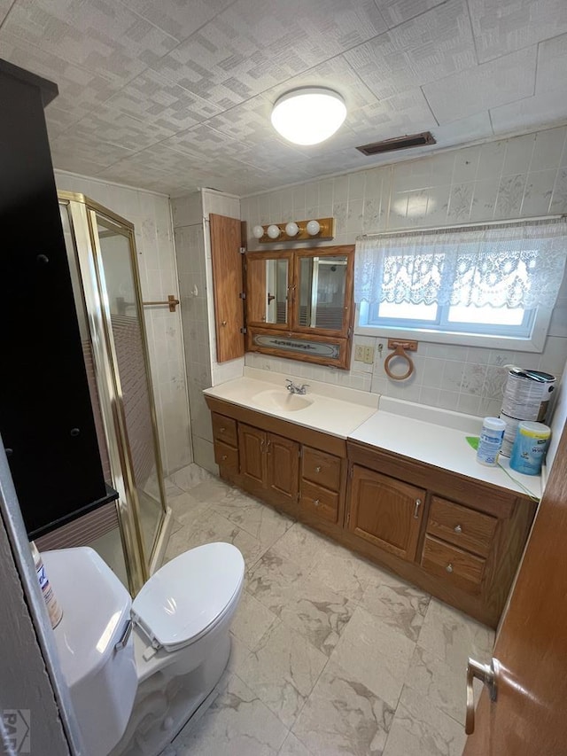 full bathroom with visible vents, toilet, marble finish floor, vanity, and a shower stall