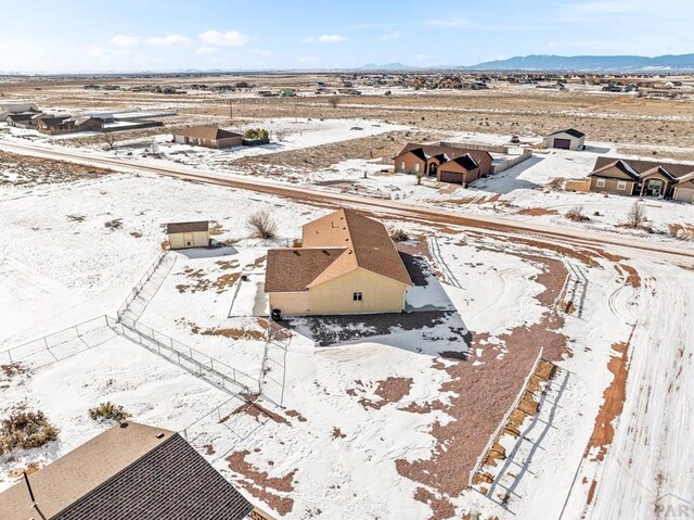 snowy aerial view featuring a mountain view