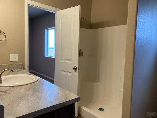 full bathroom featuring a stall shower and vanity