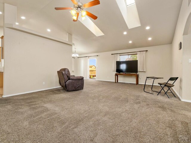 sitting room featuring a skylight, baseboards, a ceiling fan, carpet, and recessed lighting