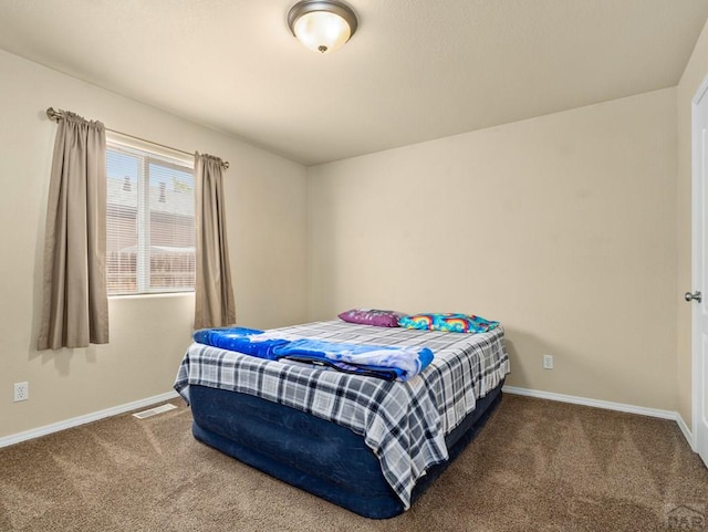 bedroom with visible vents, baseboards, and carpet flooring