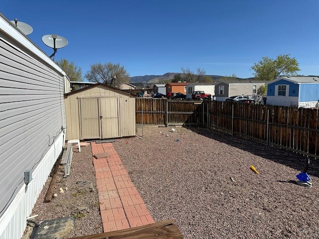 2795 Elizabeth St Unit 39, Canon City, CO 81212 - view of yard with a storage shed, a fenced backyard, a residential view, and an outbuilding