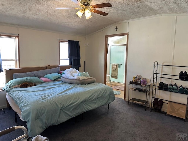 2795 Elizabeth St Unit 39, Canon City, CO 81212 - carpeted bedroom with crown molding, ensuite bathroom, a ceiling fan, and a textured ceiling