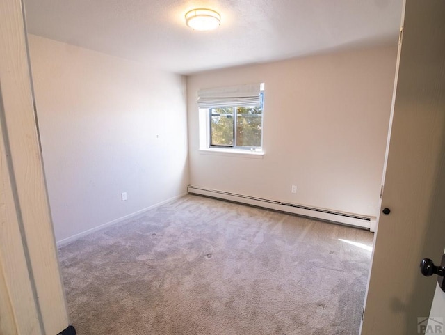 empty room with baseboard heating and carpet flooring