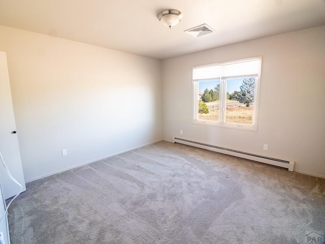 unfurnished room featuring a baseboard heating unit, visible vents, and carpet floors