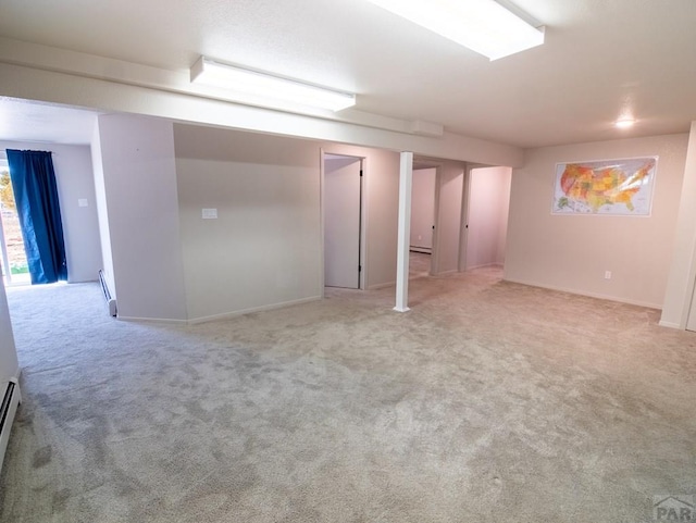 basement with a baseboard heating unit and carpet flooring