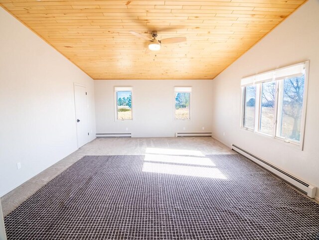 empty room with lofted ceiling, baseboard heating, carpet, and wooden ceiling