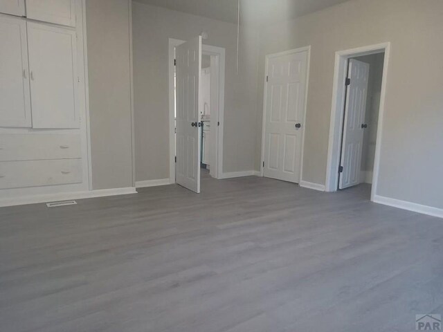 1025 W 17th St, Pueblo, CO 81003 - unfurnished bedroom with wood finished floors and baseboards