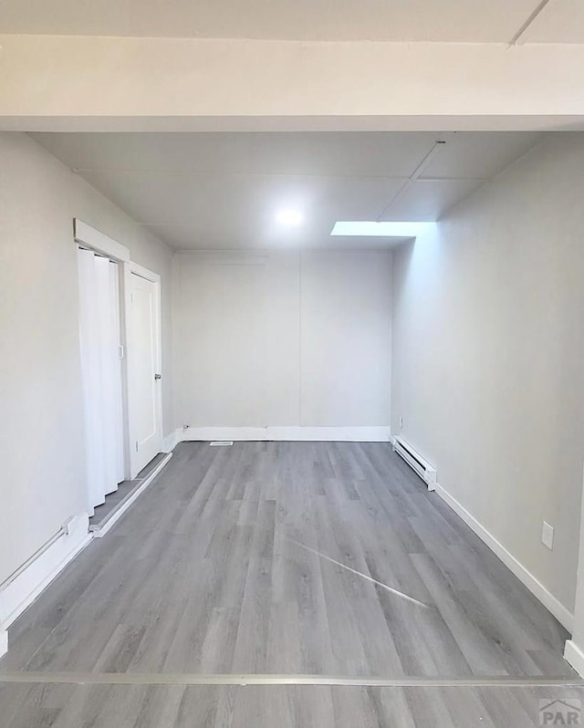 1025 W 17th St, Pueblo, CO 81003 - finished basement with baseboard heating, wood finished floors, and baseboards