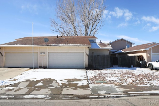 view of front of property featuring a garage and stucco siding