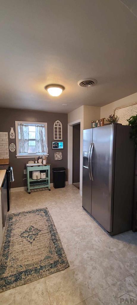 kitchen with visible vents and stainless steel fridge with ice dispenser