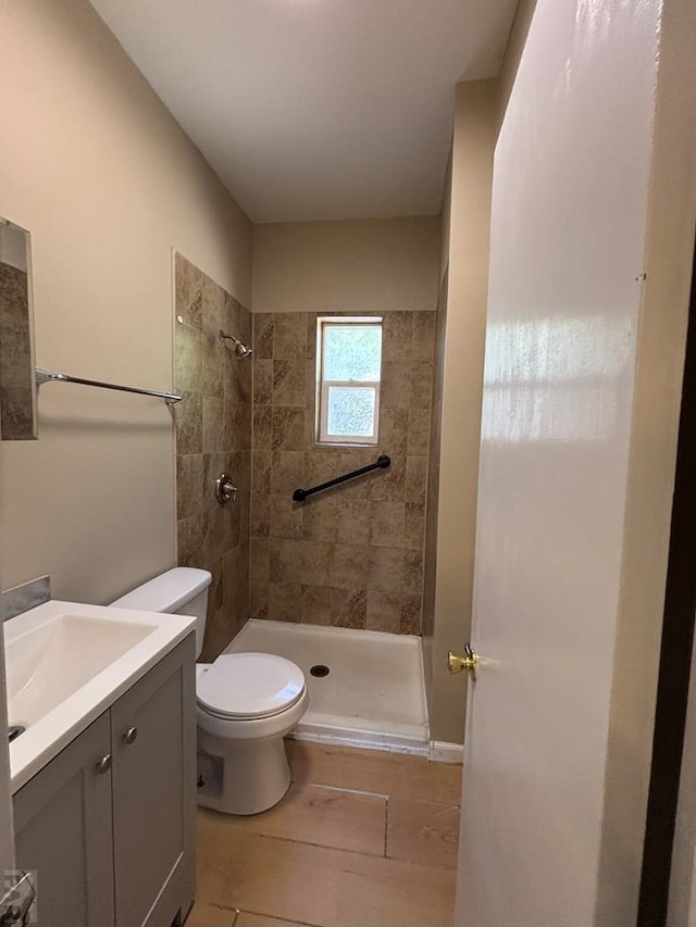 1610 E 6th St, Pueblo, CO 81001 - full bathroom featuring a shower stall, vanity, toilet, and wood finished floors