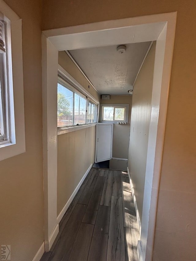 1610 E 6th St, Pueblo, CO 81001 - hallway with plenty of natural light, baseboards, and wood finished floors