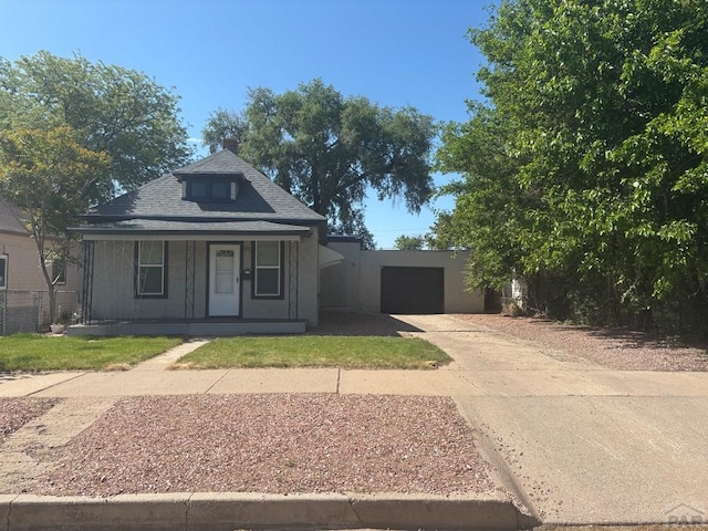 1610 E 6th St, Pueblo, CO 81001 - view of front of property with driveway, a porch, a garage, and a shingled roof