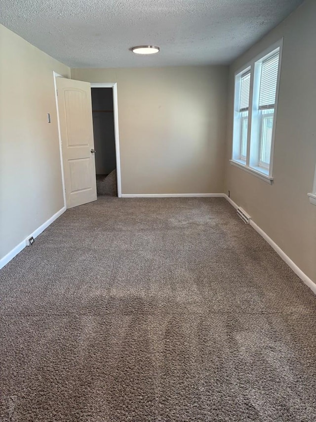 1610 E 6th St, Pueblo, CO 81001 - carpeted empty room featuring a textured ceiling and baseboards