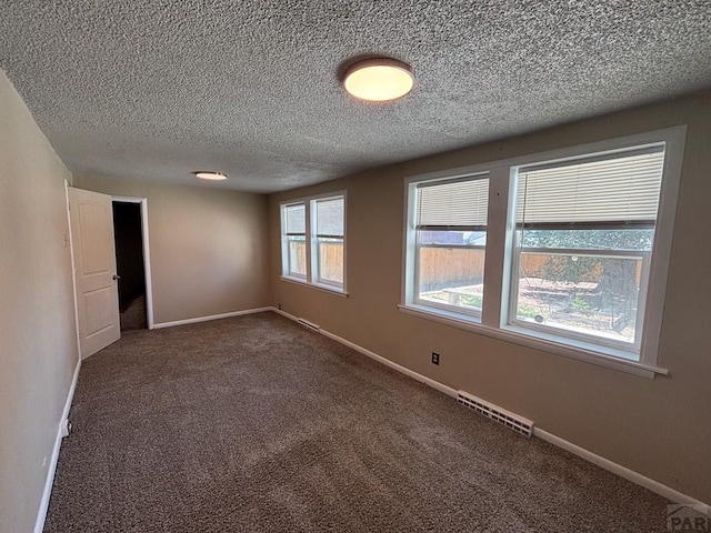 1610 E 6th St, Pueblo, CO 81001 - carpeted empty room featuring a textured ceiling and baseboards