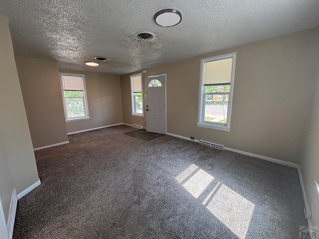 1610 E 6th St, Pueblo, CO 81001 - entryway featuring carpet flooring, a textured ceiling, and baseboards