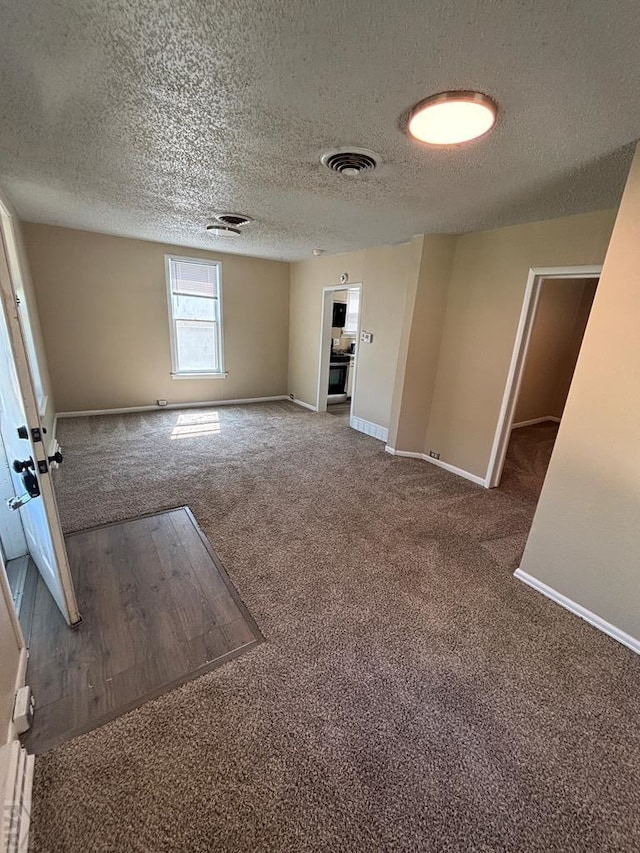 1610 E 6th St, Pueblo, CO 81001 - carpeted empty room with baseboards and a textured ceiling