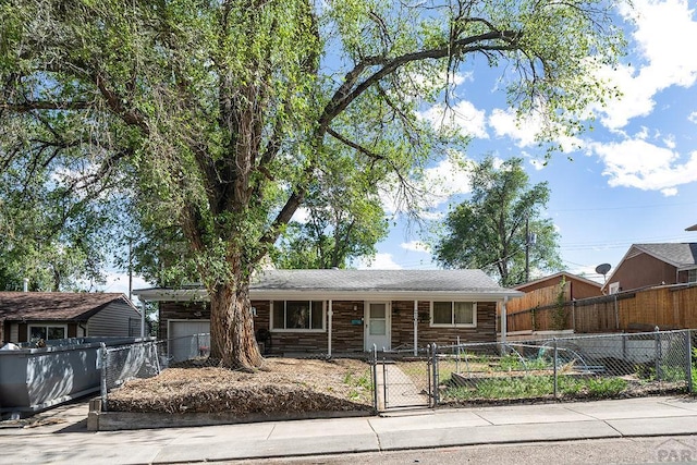 2101 Salt Dr, Colorado Springs, CO 80910 - single story home featuring a fenced front yard, a gate, and covered porch