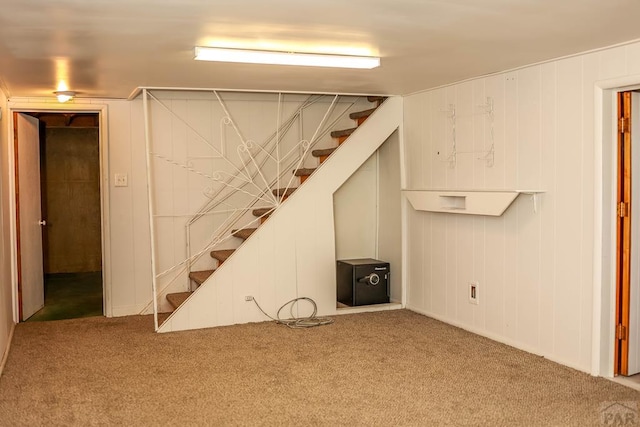 finished basement featuring carpet flooring and stairs