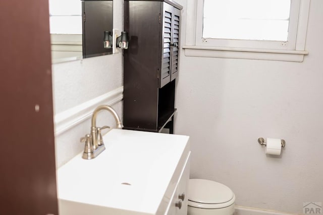 bathroom featuring toilet and vanity