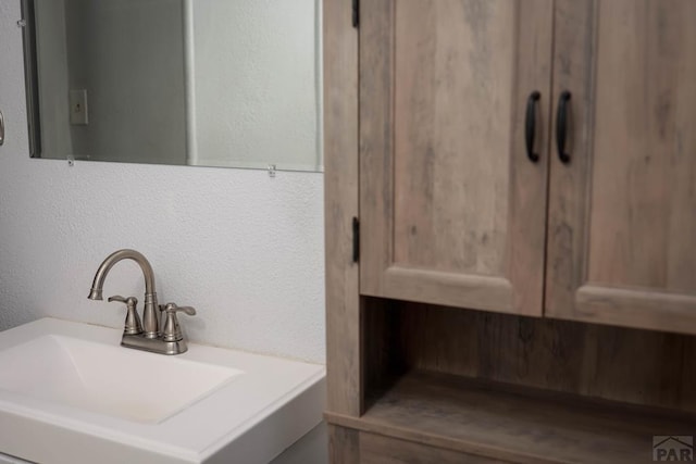 bathroom with a sink and a textured wall