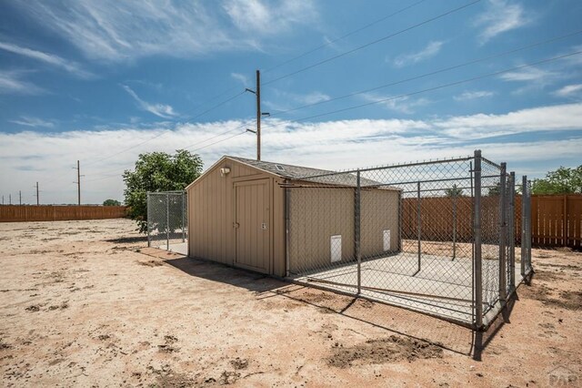 view of shed featuring fence