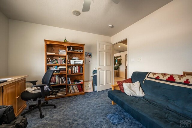 office with ceiling fan and dark carpet