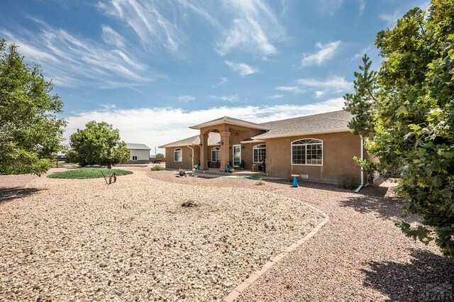 back of house featuring stucco siding